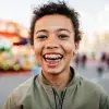 Smiling young person showing arch wires in braces
